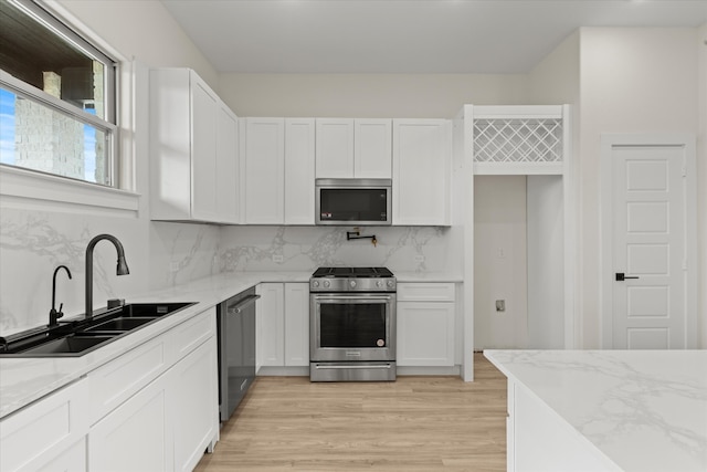 3725 Creek View Dr, Mckinney, TX 75071 - kitchen with appliances with stainless steel finishes, a sink, light stone countertops, white cabinetry, and recessed lighting