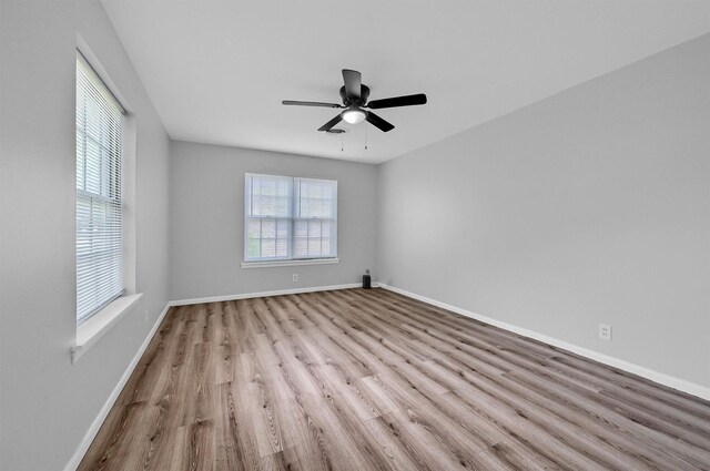 506 Melody Ln, Gainesville, TX 76240 - spare room featuring wood finished floors, ceiling fan, and baseboards