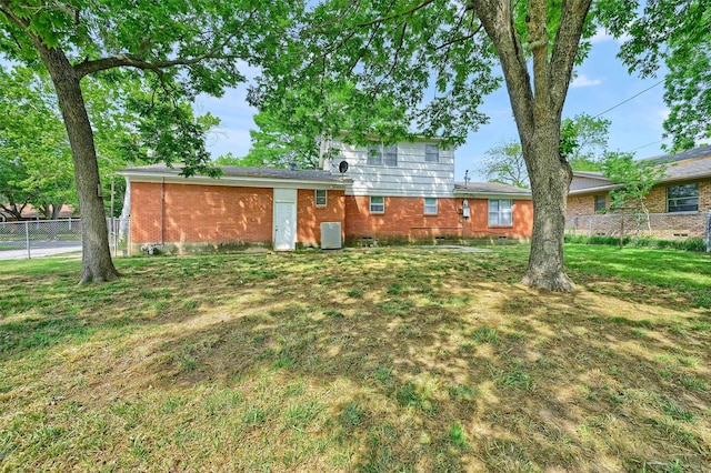 506 Melody Ln, Gainesville, TX 76240 - back of property featuring brick siding and central air condition unit