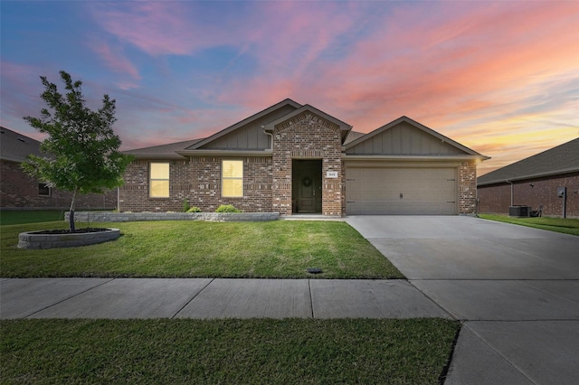 312 Duke Ct, Fate, TX 75189 - ranch-style house featuring board and batten siding, driveway, a garage, a lawn, and brick siding