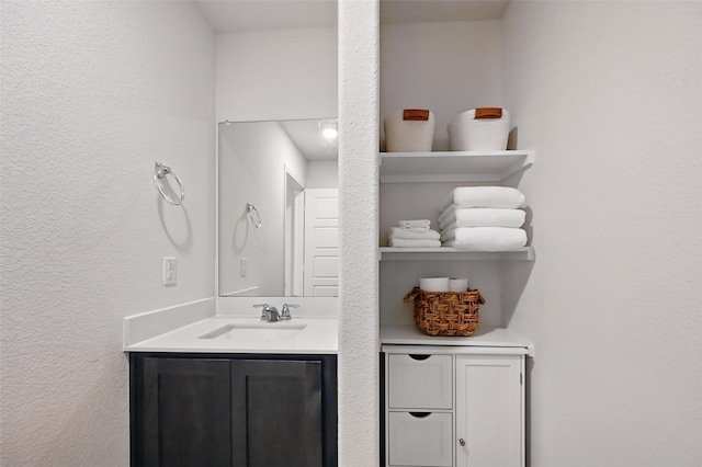 312 Duke Ct, Fate, TX 75189 - bathroom with a textured wall and vanity