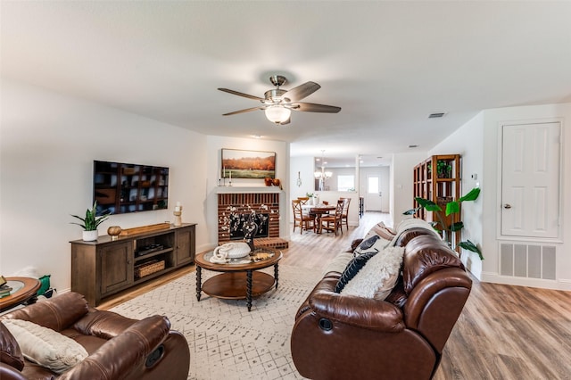 2120 Burnside Dr, Fort Worth, TX 76177 - living area with light wood-type flooring, ceiling fan, baseboards, and a chandelier