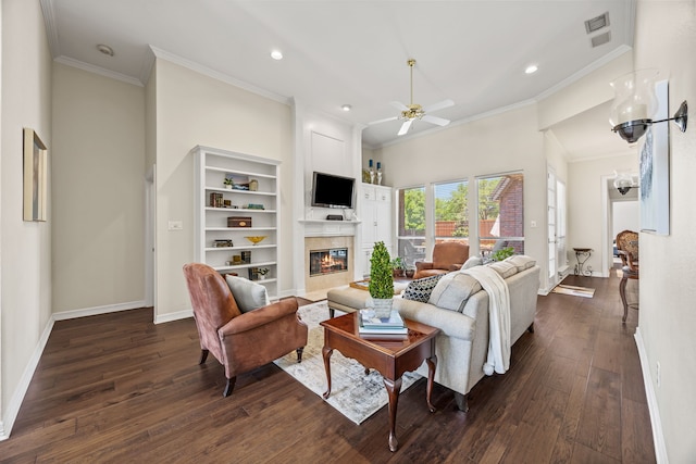 508 Wellington Rd, Coppell, TX 75019 - living area with a ceiling fan, ornamental molding, a tiled fireplace, dark wood finished floors, and baseboards