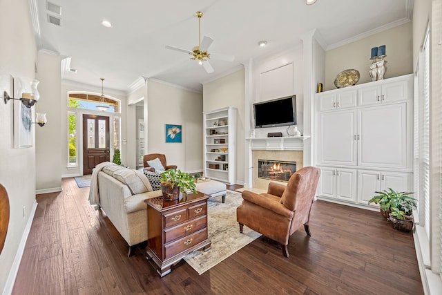 508 Wellington Rd, Coppell, TX 75019 - living area with crown molding, ceiling fan, dark wood-style floors, a high end fireplace, and baseboards