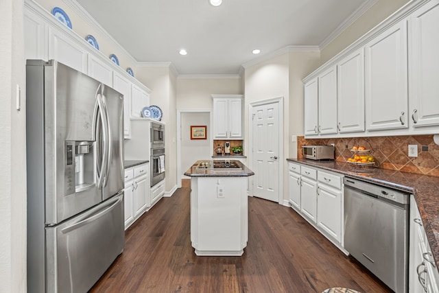 508 Wellington Rd, Coppell, TX 75019 - kitchen featuring appliances with stainless steel finishes, white cabinetry, ornamental molding, a center island, and recessed lighting