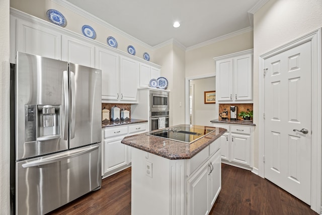 508 Wellington Rd, Coppell, TX 75019 - kitchen with appliances with stainless steel finishes, decorative backsplash, white cabinetry, a kitchen island, and crown molding