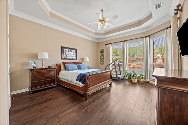 508 Wellington Rd, Coppell, TX 75019 - bedroom with dark wood-style floors, a raised ceiling, ornamental molding, a ceiling fan, and baseboards