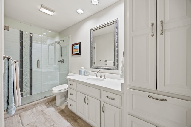 508 Wellington Rd, Coppell, TX 75019 - bathroom with toilet, a shower stall, vanity, and wood finished floors