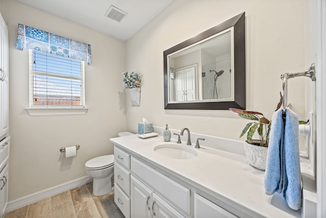 508 Wellington Rd, Coppell, TX 75019 - full bath with vanity, toilet, baseboards, a shower, and wood finished floors