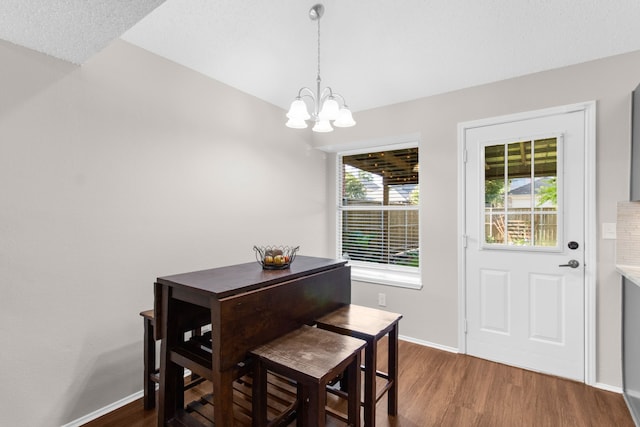 4411 Cordova Ln, Mckinney, TX 75070 - dining space featuring a chandelier, dark wood-style floors, and baseboards