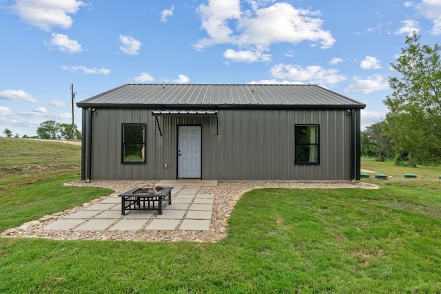 400 Round Up Ct, Stephenville, TX 76401 - back of house featuring a patio, a yard, a fire pit, and metal roof