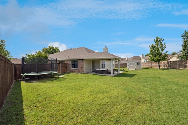 14065 Tanglebrush Trl, Fort Worth, TX 76052 - back of house with a trampoline, a patio, a chimney, and brick siding