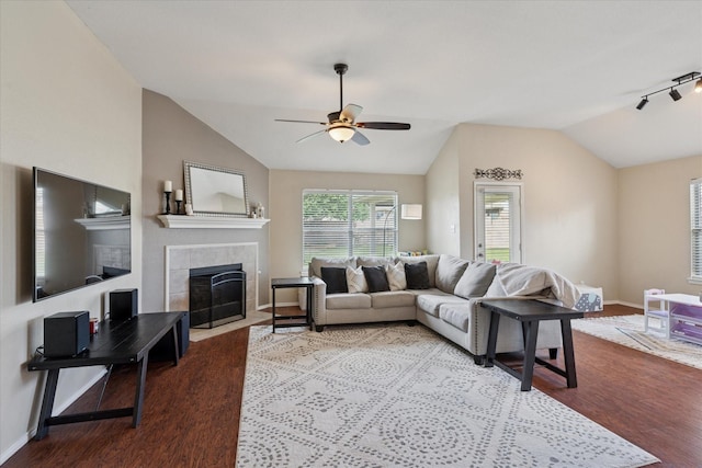 14065 Tanglebrush Trl, Fort Worth, TX 76052 - living area featuring vaulted ceiling, wood finished floors, a tile fireplace, a ceiling fan, and baseboards