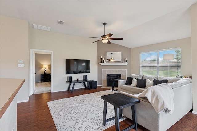 14065 Tanglebrush Trl, Fort Worth, TX 76052 - living area with a tiled fireplace, dark wood-style floors, a ceiling fan, vaulted ceiling, and baseboards