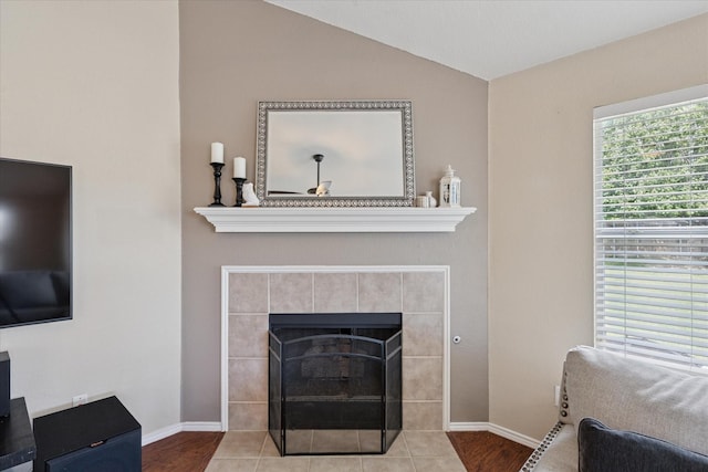 14065 Tanglebrush Trl, Fort Worth, TX 76052 - living room featuring a tile fireplace, lofted ceiling, baseboards, and wood finished floors