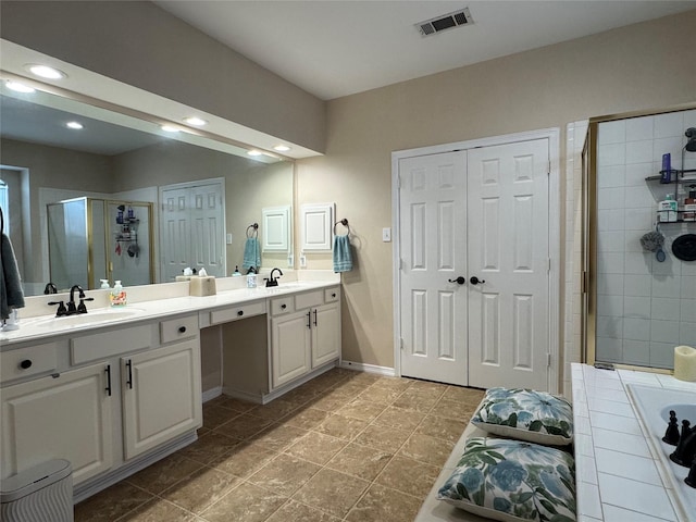 135 Freedom Ct, Rockwall, TX 75032 - full bathroom featuring double vanity, a stall shower, a tub to relax in, recessed lighting, and baseboards