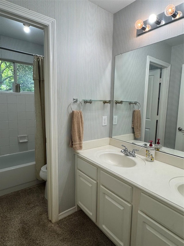 135 Freedom Ct, Rockwall, TX 75032 - bathroom with double vanity, wallpapered walls, toilet, and shower / tub combo