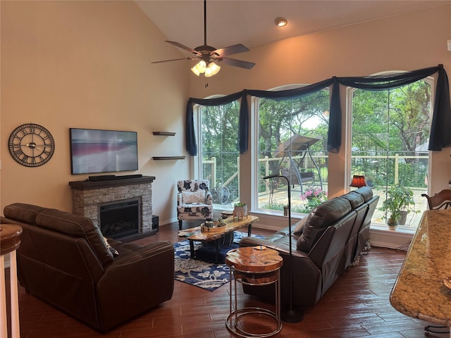 135 Freedom Ct, Rockwall, TX 75032 - living area featuring a fireplace, ceiling fan, dark wood-type flooring, healthy amount of natural light, and lofted ceiling