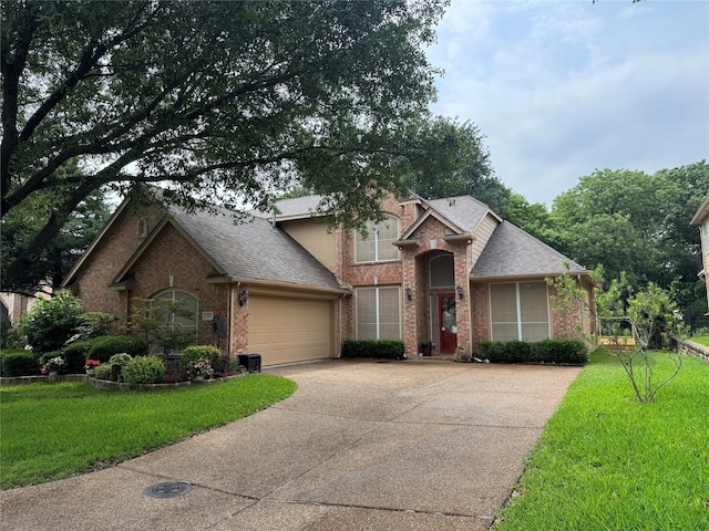 135 Freedom Ct, Rockwall, TX 75032 - traditional home with concrete driveway, brick siding, a garage, and a shingled roof