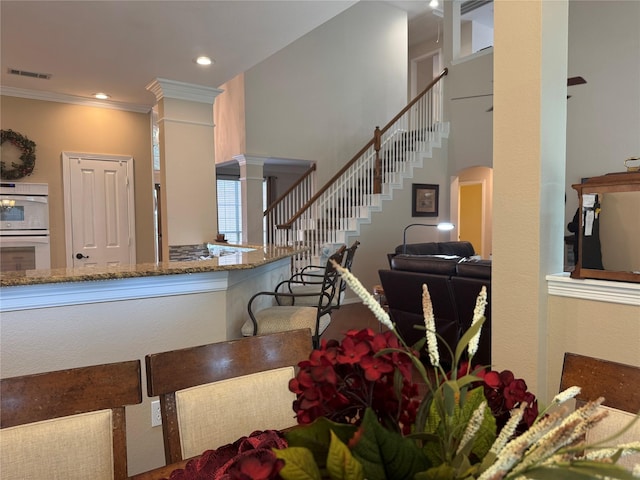 135 Freedom Ct, Rockwall, TX 75032 - dining room featuring ornate columns, stairway, crown molding, and recessed lighting