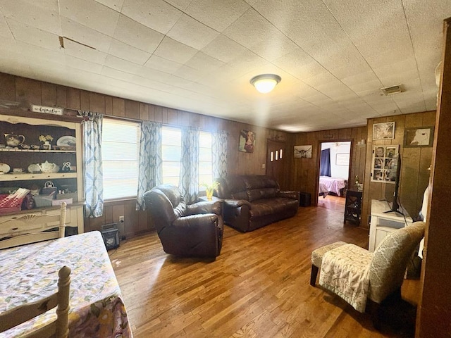 1103 Albert Broadfoot St, Bonham, TX 75418 - living room featuring wood walls and wood finished floors