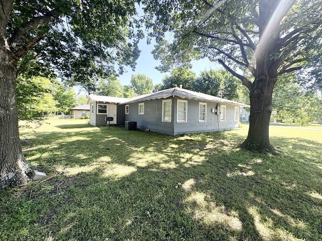 1103 Albert Broadfoot St, Bonham, TX 75418 - view of side of property featuring central AC and a lawn
