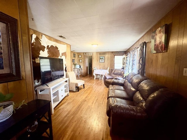 1103 Albert Broadfoot St, Bonham, TX 75418 - living area with light wood-style floors and wood walls