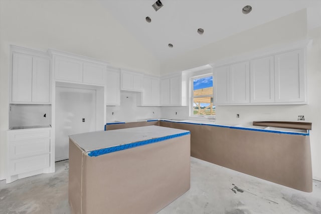 132 S Baese Rd, Elm Mott, TX 76640 - kitchen featuring a center island, concrete flooring, white cabinets, and high vaulted ceiling