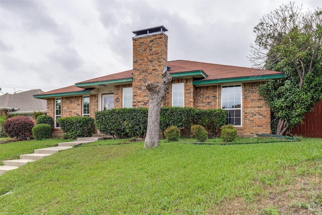 1740 Northview, Carrollton, TX 75007 - view of front facade featuring a chimney, brick siding, and a front yard