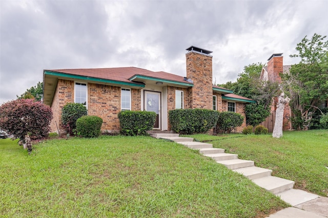 1740 Northview, Carrollton, TX 75007 - view of front of home with a front lawn, a chimney, and brick siding
