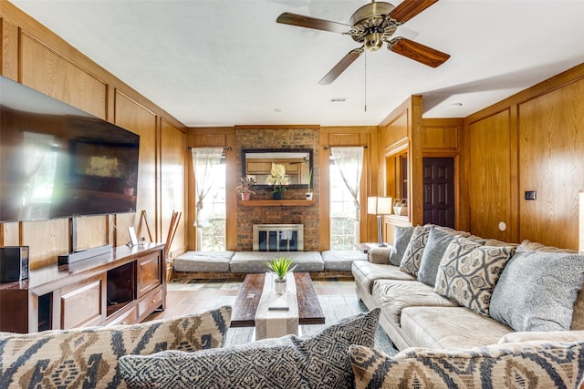 1740 Northview, Carrollton, TX 75007 - living area featuring light wood-style floors, wood walls, a ceiling fan, and a fireplace