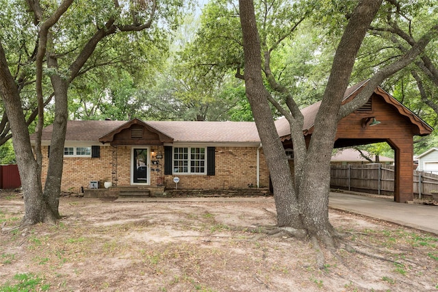 1606 S Jefferson St, Kaufman, TX 75142 - view of front facade with fence, brick siding, and roof with shingles