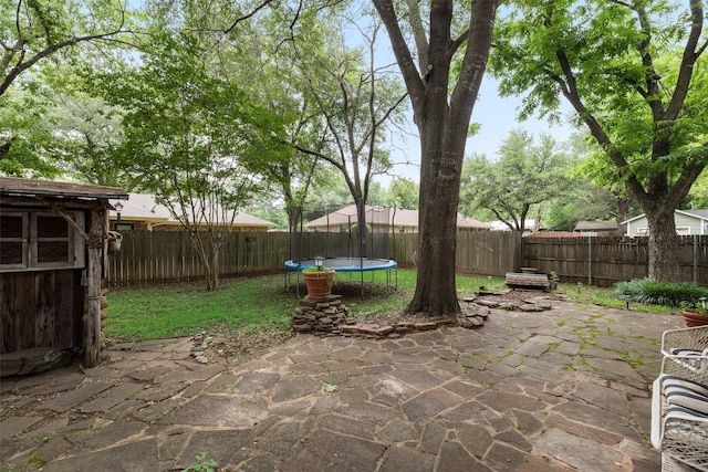 1606 S Jefferson St, Kaufman, TX 75142 - view of patio / terrace featuring a fenced backyard and a trampoline