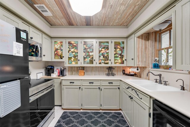 1606 S Jefferson St, Kaufman, TX 75142 - kitchen with black appliances, a sink, light countertops, ornamental molding, and wooden ceiling