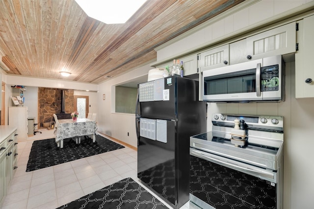 1606 S Jefferson St, Kaufman, TX 75142 - kitchen featuring stainless steel appliances, wood ceiling, a wood stove, and light countertops