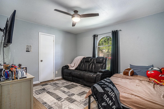 629 Barbara Ln, Burleson, TX 76028 - bedroom featuring wood finished floors, a ceiling fan, baseboards, and a textured wall