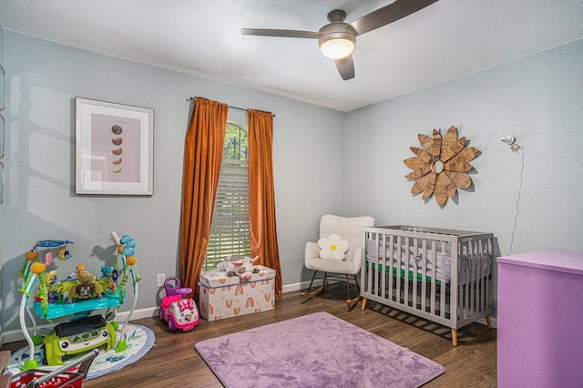 629 Barbara Ln, Burleson, TX 76028 - bedroom with a crib, wood finished floors, a ceiling fan, and baseboards