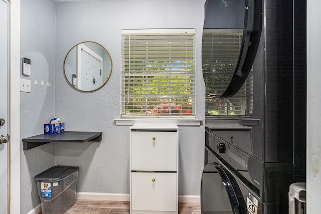 629 Barbara Ln, Burleson, TX 76028 - washroom with wood finished floors, baseboards, washer / dryer, and a textured wall