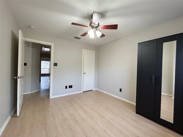 2114 Montclair Ln, Lewisville, TX 75067 - unfurnished bedroom featuring light wood-type flooring, baseboards, and a ceiling fan