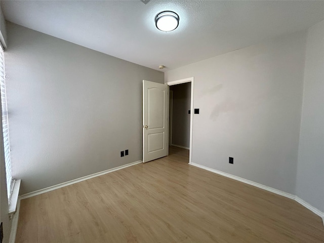 2114 Montclair Ln, Lewisville, TX 75067 - unfurnished room featuring light wood-style flooring and baseboards