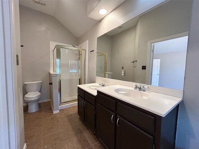 2114 Montclair Ln, Lewisville, TX 75067 - full bath featuring toilet, a shower stall, tile patterned flooring, vaulted ceiling, and double vanity