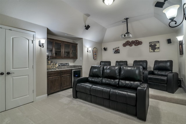 611 Southwestern Dr, Rockwall, TX 75087 - cinema featuring light carpet, bar with sink, vaulted ceiling, beverage cooler, and baseboards