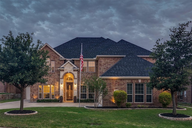 611 Southwestern Dr, Rockwall, TX 75087 - view of front of property featuring a shingled roof, brick siding, and a front yard