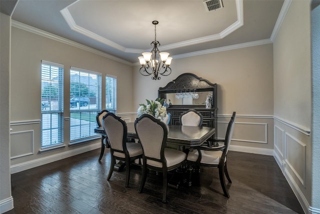 611 Southwestern Dr, Rockwall, TX 75087 - dining room featuring a raised ceiling, a chandelier, dark wood finished floors, wainscoting, and crown molding