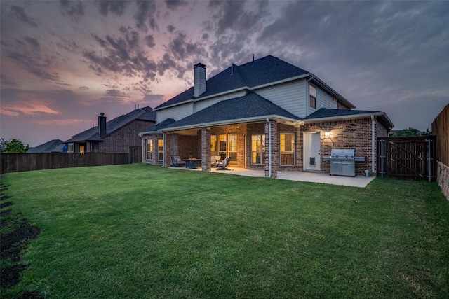 611 Southwestern Dr, Rockwall, TX 75087 - rear view of house with brick siding, a patio area, a chimney, and a shingled roof