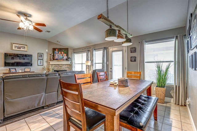 544 Bent Oak Dr, Fort Worth, TX 76131 - dining space with lofted ceiling, light tile patterned flooring, ceiling fan, a fireplace, and baseboards