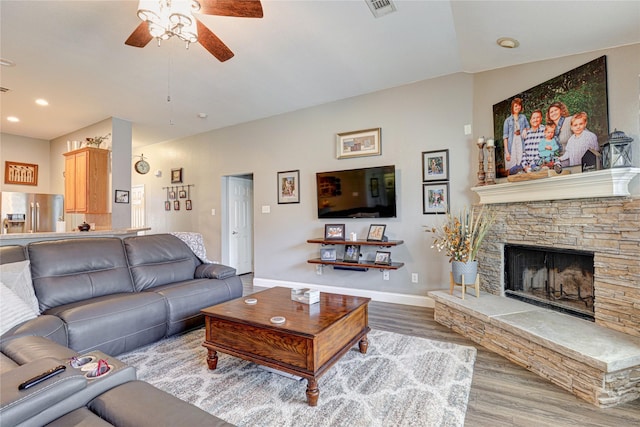 544 Bent Oak Dr, Fort Worth, TX 76131 - living room featuring a ceiling fan, wood finished floors, baseboards, a stone fireplace, and recessed lighting
