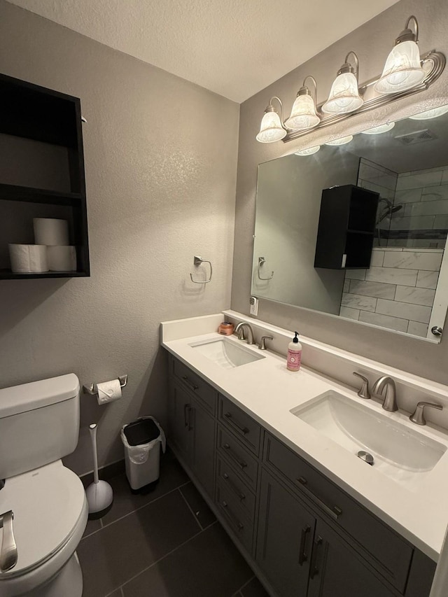 544 Bent Oak Dr, Fort Worth, TX 76131 - bathroom featuring toilet, a textured ceiling, tile patterned flooring, double vanity, and baseboards