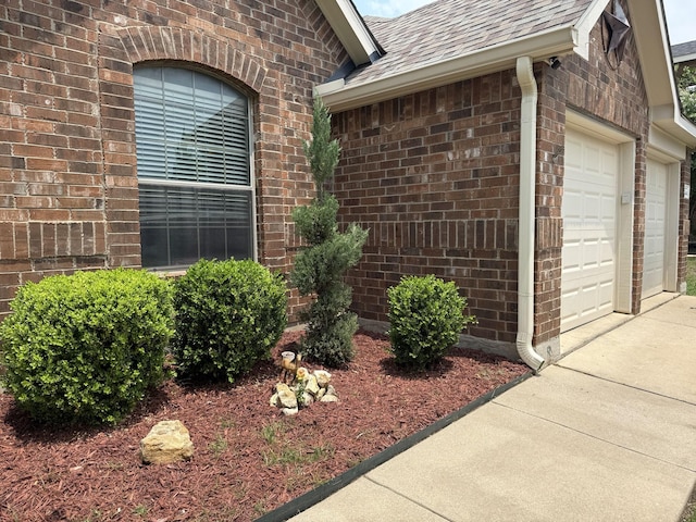 544 Bent Oak Dr, Fort Worth, TX 76131 - property entrance with brick siding, an attached garage, roof with shingles, and driveway