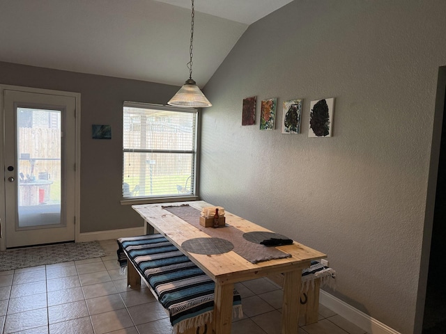 544 Bent Oak Dr, Fort Worth, TX 76131 - dining room with vaulted ceiling, healthy amount of natural light, a textured wall, tile patterned floors, and baseboards
